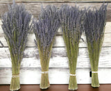 Four bundles of lavender on a wooden surface