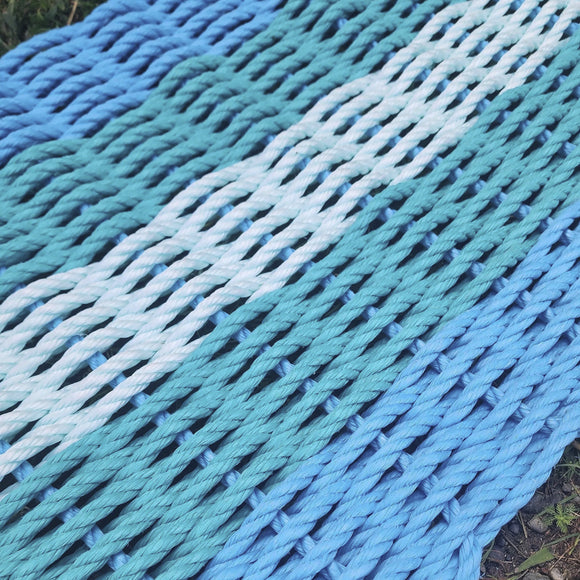 Close-up of blue and green rope on a grassy surface