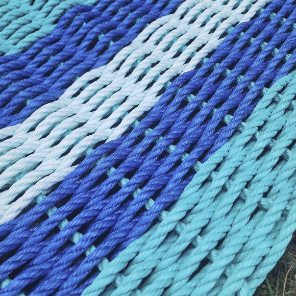 Close-up of a blue and green rope mat on grass