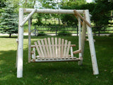 Wooden swing set in a grassy outdoor area with trees and a fence in the background.