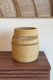 Woven basket on a wooden surface with a neutral background