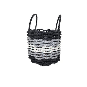 Woven basket with black and gray pattern on a white background