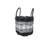 Woven basket with black, gray, and white pattern on a white background