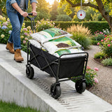 Person pushing a black folding cart with gardening supplies in a garden setting