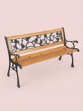 Wooden bench with black metal armrests and backrest on a beige background