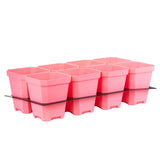 Set of pink plant pots with a clear tray on a white background