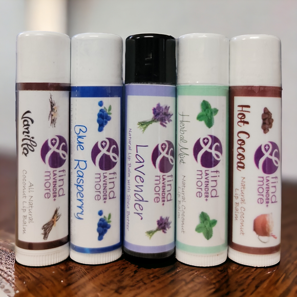 Five lip balm tubes with different scents on a wooden surface