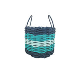 Woven basket with blue and green pattern on a white background