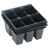 Stack of black plastic seedling trays on a white background