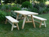 Wooden picnic table with benches in a garden setting