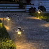 Solar-powered outdoor lights illuminating a pathway in front of a house.