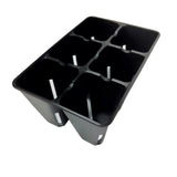 Black plastic seed tray with multiple compartments on a white background