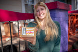Woman holding TURMERiC + Rose WATeR FACE & BODY SOAP  5 oz.