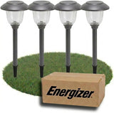Four solar-powered garden lights on grass with an Energizer box in front.