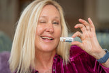 Woman holding VANILLA SWIRL LUXURY LIP BUTTER™ - THE APPALACHIAN GOAT with a blurred background