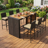 A 7-piece outdoor wicker patio dining set with a rectangular bar-height table and six matching high-back chairs, shown on a wooden deck in a backyard garden setting.