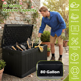 A man in a blue work shirt and khaki shorts is standing next to an open black 80-gallon storage bin filled with gardening tools in an outdoor garden setting. A vertical green sidebar on the right lists features like cushion, blankets, pillows, gardening tools, packages, and pool supplies, with an inset showing the bottom of the bin labeled 80 Gallon.