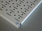 White pegboard with holes on a gray background
