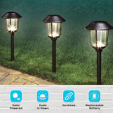 Three solar-powered outdoor lights on grass with features listed below.