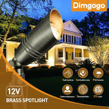 Brass spotlight with Dimgogo branding in front of a house at night.