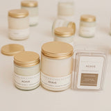 Candle jars with gold lids and 'Westend Collective' branding on a light background Agave Products