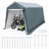 Gray A-frame carport shelter with a side wall, shown with a motorcycle and green lawnmower inside for scale, plus included ground stakes and rope on a white background.
