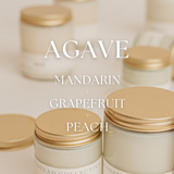 Jars with gold lids labeled 'Agave Mandarin Grapefruit Peach' on a neutral background