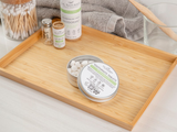 Bamboo tray with dental products including toothpaste tablets on a neutral background