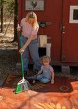Woman and child cleaning a Daisy Rust rug