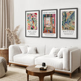Living room with a white sofa, wooden coffee table, and three framed Henri Matisse artworks on the wall.