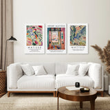 Living room with a white sofa, wooden coffee table, and Matisse art prints on the wall.