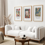 Living room with a white sofa, wooden coffee table, and framed Matisse art on the wall.