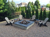 Fire pit with Adirondack chairs in a backyard setting