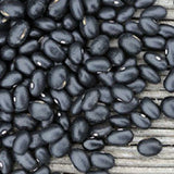 Close-up of black BEAN Seeds, Black Midnight Bush beans on a wooden surface 