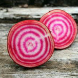 Two sliced beets on a wooden surface BEET Seeds, Chioggia

