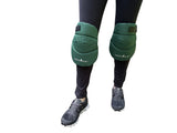 Green knee pads worn by a person on a white background