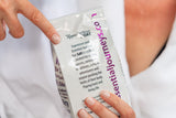 Person holding a package of 'Essential Journeys' salt, with text on the packaging.