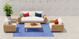 Outdoor furniture set with a sofa, chairs, and coffee table on a Basic Blue & White rug.