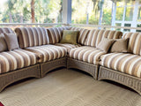 Striped outdoor sectional sofa with cushions on a Basic Cream & Brown rug