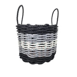 Woven basket with black and gray pattern on a white background