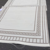 Textile sample Border White Sand Outdoor Rug with a geometric border design on a plain background