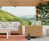 Outdoor patio furniture set with a scenic background of green hills. Basket Weave Brown Oxide