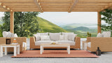 Outdoor patio set with white cushions and wooden furniture under a wooden pergola with a scenic view. Basket Weave Brown Oxide