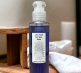 Bottle of lavender gel with a label on a wooden surface