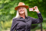 Woman wearing a brown hat holding PROSECCO SOAP SLICE 5 oz.