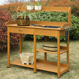 Wooden potting bench with plants and gardening tools outdoors