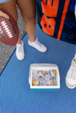 Person holding a football with a cooler and towel on a Basic Blue & White mat