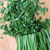 Chopped green chives on a wooden surface CHIVE Seeds, Allium Schoeno