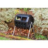 Black compost bin with garden waste in a garden setting