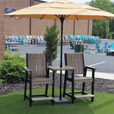 Outdoor patio set with two Callaway Chair Counter High chairs and a table under an umbrella on a grassy area.